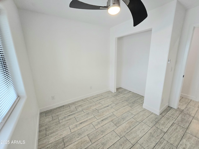 empty room featuring ceiling fan, wood finish floors, and baseboards