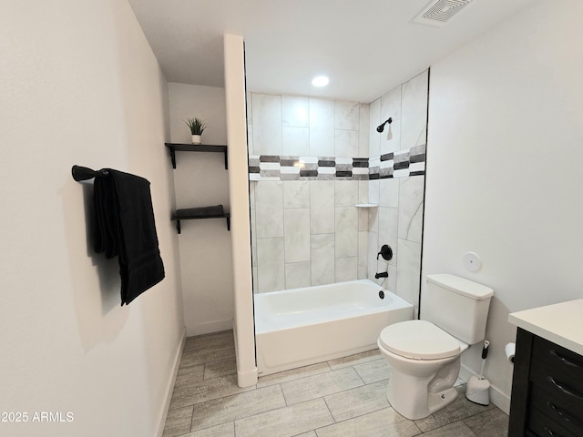 bathroom featuring visible vents, toilet, vanity, wood tiled floor, and shower / bathtub combination