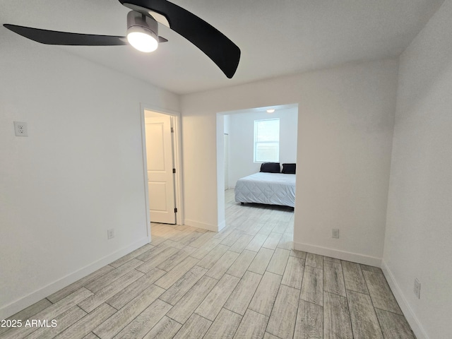 unfurnished bedroom featuring a ceiling fan, wood finish floors, and baseboards