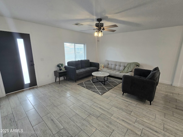 living area featuring a ceiling fan, light wood-type flooring, and visible vents