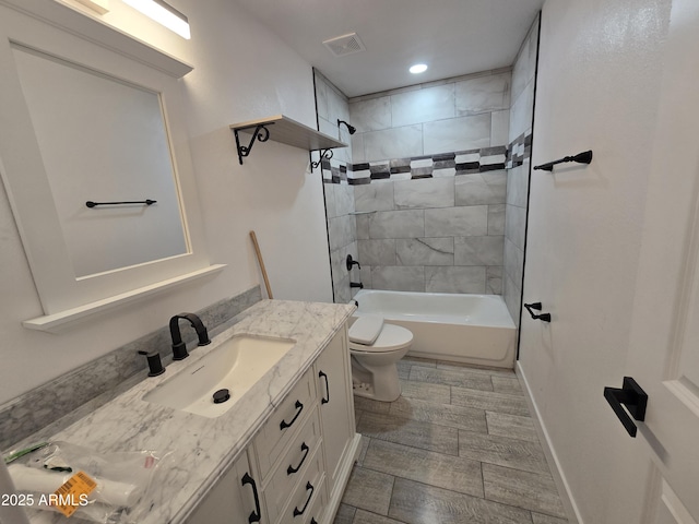 full bathroom with baseboards, visible vents, toilet, bathtub / shower combination, and vanity