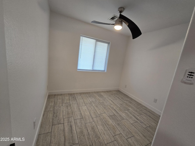 unfurnished room featuring visible vents, ceiling fan, baseboards, and wood finished floors