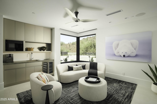 living room featuring sink, ceiling fan, and wine cooler