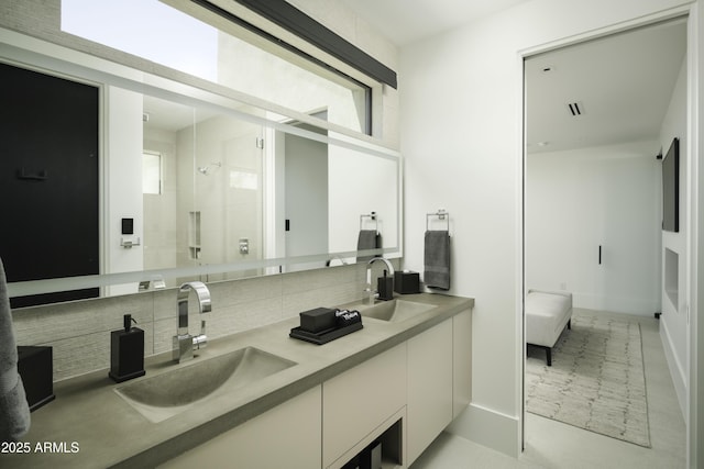 bathroom featuring tasteful backsplash, a healthy amount of sunlight, and vanity