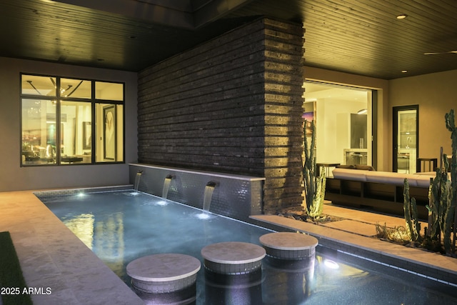 view of swimming pool featuring a hot tub