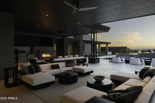 view of patio featuring grilling area, ceiling fan, an outdoor living space with a fireplace, and area for grilling