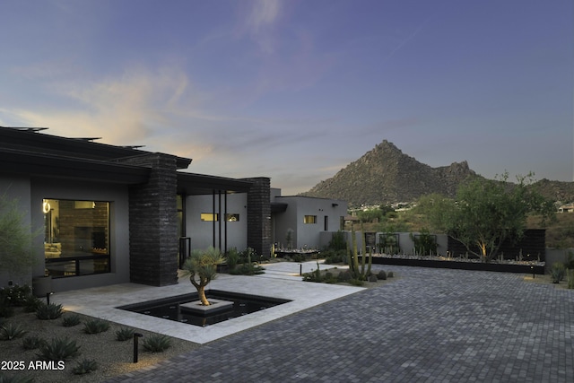 patio terrace at dusk with a mountain view