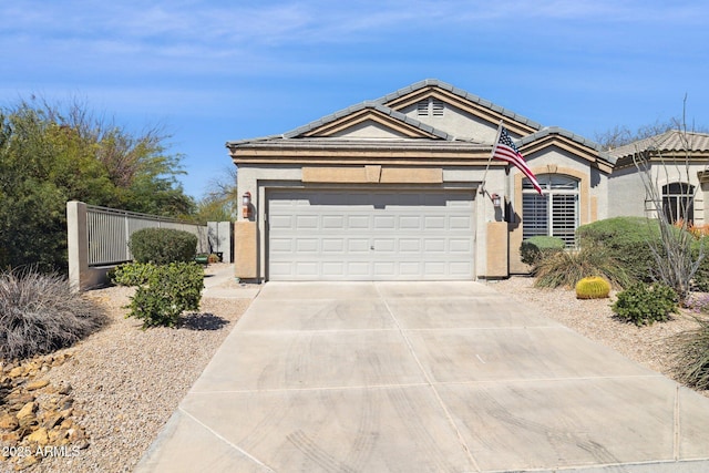 view of front facade featuring an attached garage, fence, a tile roof, stucco siding, and driveway