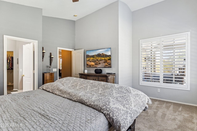 bedroom featuring baseboards, high vaulted ceiling, and carpet flooring