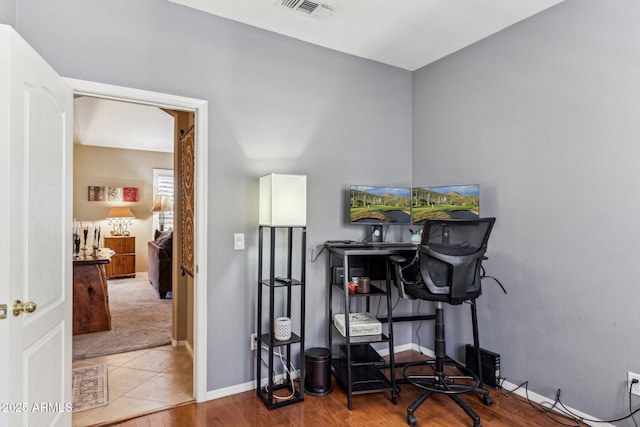 home office with wood finished floors, baseboards, and visible vents