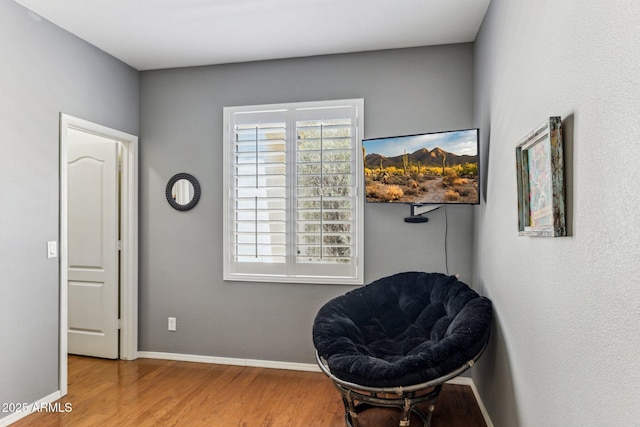sitting room featuring baseboards and wood finished floors