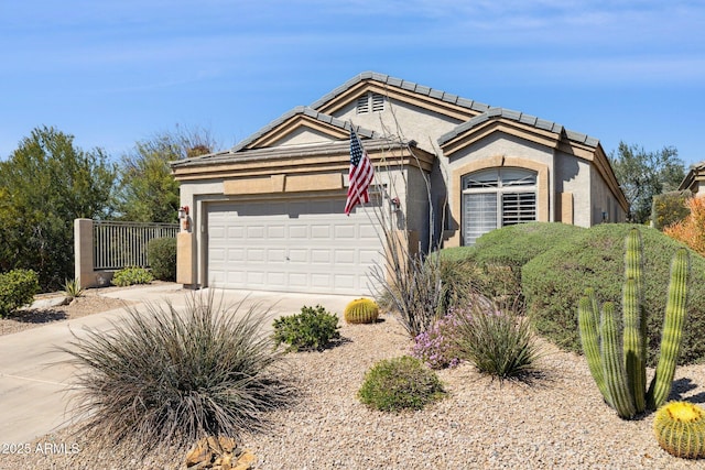 view of front of house featuring concrete driveway, a garage, and stucco siding