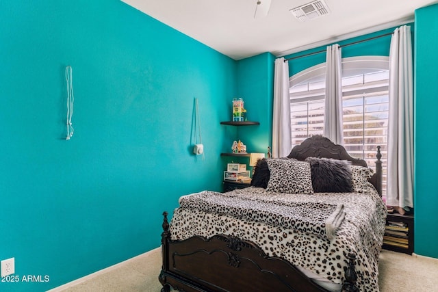 carpeted bedroom with visible vents and ceiling fan