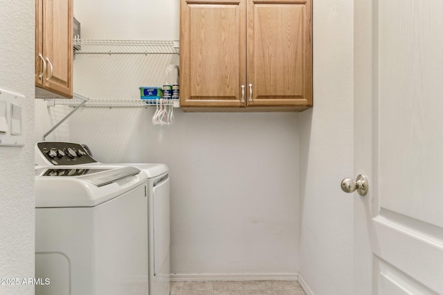 laundry area with cabinet space, washer and dryer, and baseboards