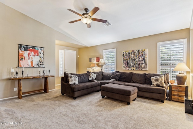 living room featuring carpet, a ceiling fan, visible vents, baseboards, and vaulted ceiling