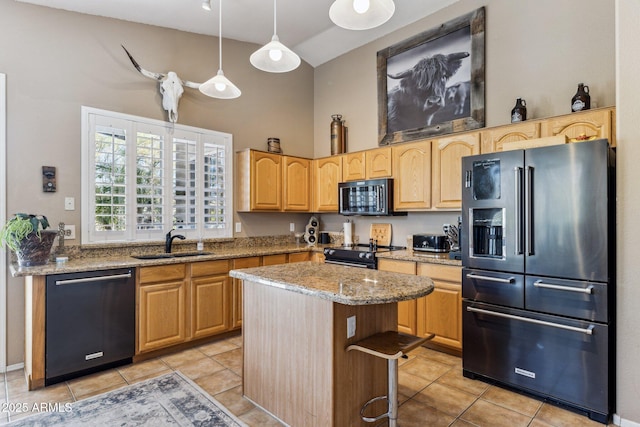 kitchen with light stone counters, a high ceiling, light tile patterned flooring, black appliances, and a sink