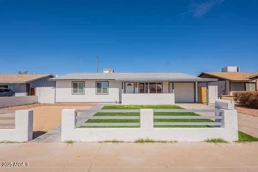 view of front of property featuring a fenced front yard and an attached garage