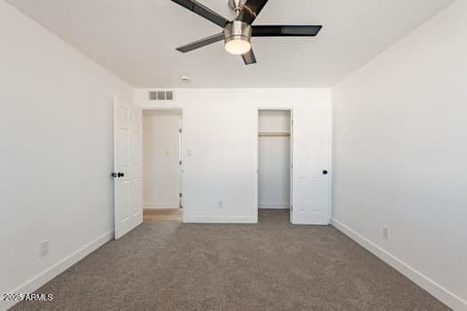 unfurnished bedroom with carpet, baseboards, and a closet