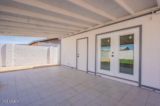 view of patio / terrace featuring french doors and fence