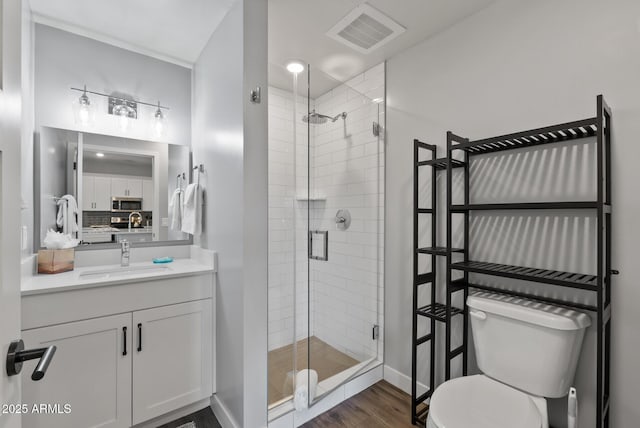 475 N 9th St Unit 206, Phoenix, AZ 85006 - bathroom with toilet, a shower stall, vanity, wood finished floors, and decorative backsplash