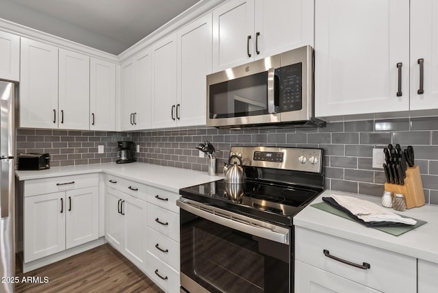 475 N 9th St Unit 206, Phoenix, AZ 85006 - kitchen with appliances with stainless steel finishes, light countertops, white cabinetry, and backsplash