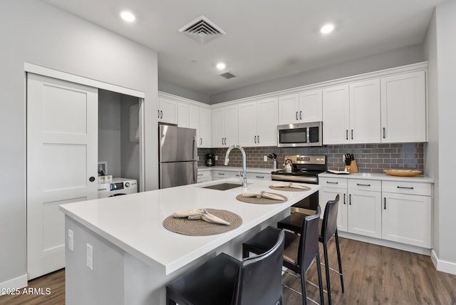 475 N 9th St Unit 206, Phoenix, AZ 85006 - kitchen with stainless steel appliances, a sink, decorative backsplash, white cabinets, and recessed lighting
