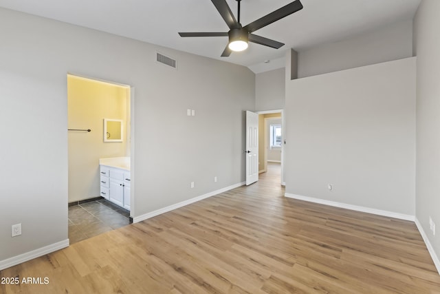 unfurnished bedroom with ensuite bath, ceiling fan, and light hardwood / wood-style floors