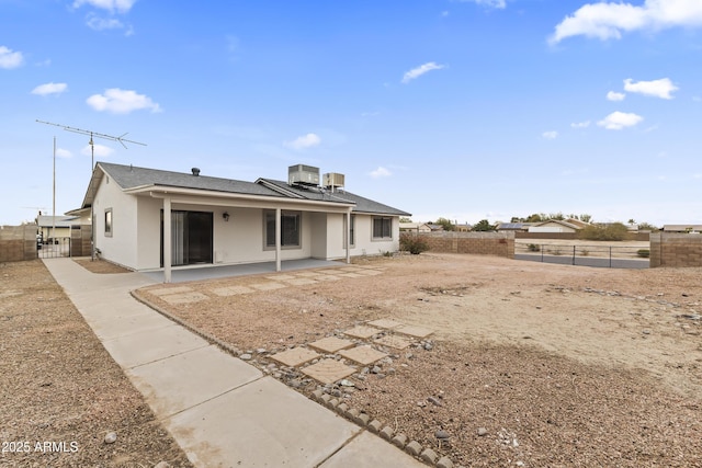 back of house with central air condition unit and a patio