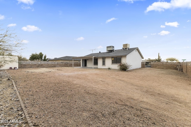 rear view of property with central AC unit