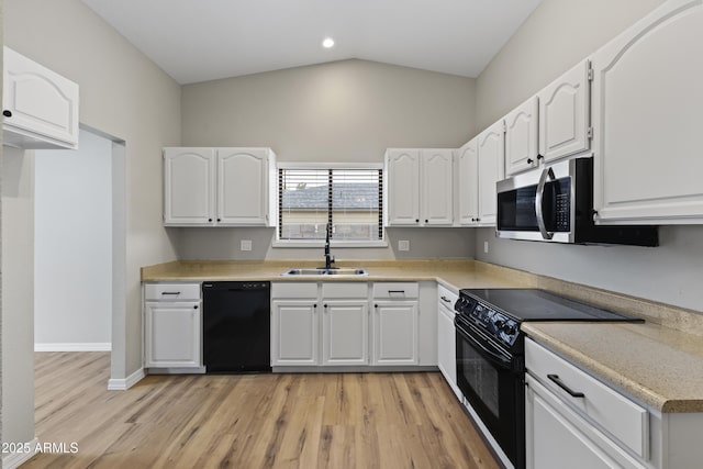 kitchen with sink, black appliances, light hardwood / wood-style flooring, white cabinets, and lofted ceiling