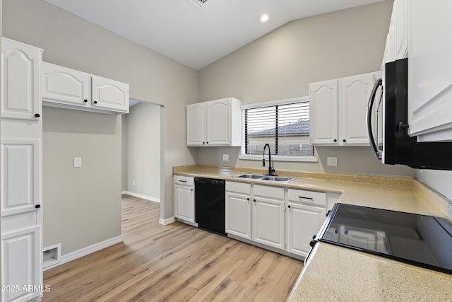 kitchen featuring sink, white cabinets, range, black dishwasher, and lofted ceiling