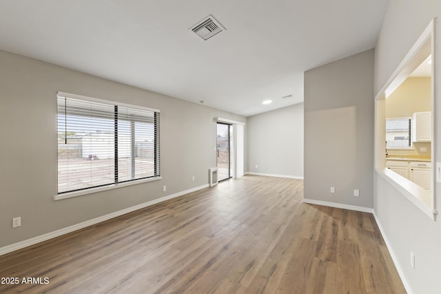 unfurnished room with light hardwood / wood-style floors