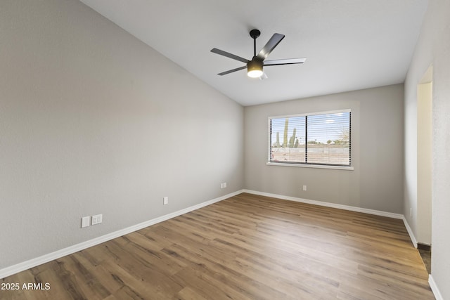 unfurnished room with lofted ceiling, ceiling fan, and wood-type flooring