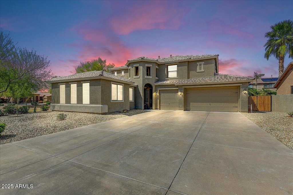 15138 W Campbell Ave, Goodyear, AZ 85395 - view of front of home with a tile roof, concrete driveway, stucco siding, fence, and an attached garage