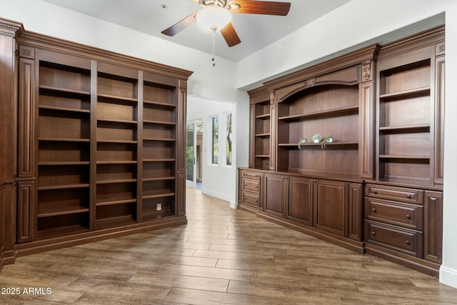 unfurnished office featuring ceiling fan and dark hardwood / wood-style flooring