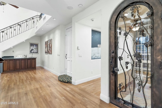 interior space with ceiling fan, light hardwood / wood-style floors, and a skylight