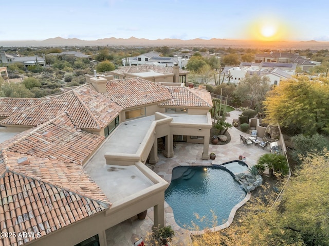 view of swimming pool featuring a mountain view and a patio area