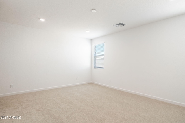 empty room featuring light colored carpet