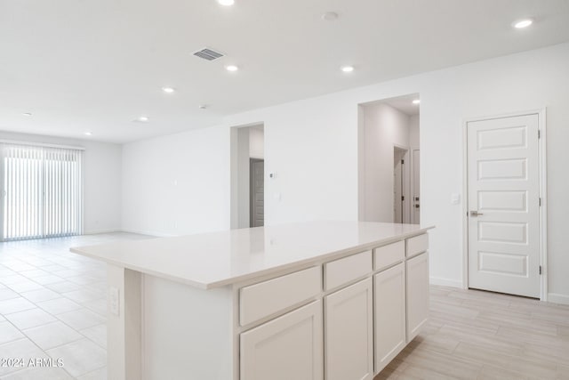 kitchen with a kitchen island and white cabinets