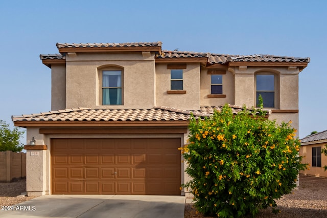 mediterranean / spanish house featuring a garage