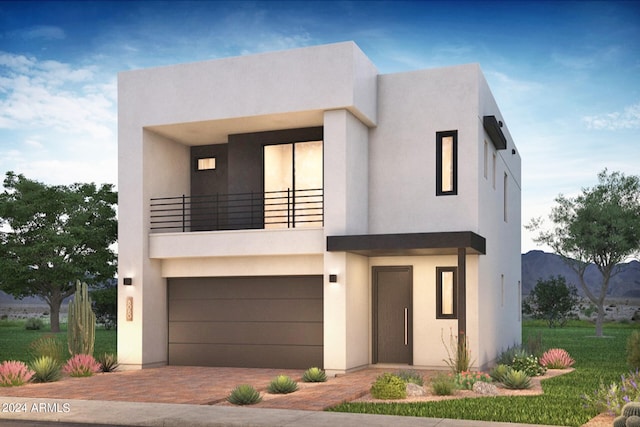 view of front of home featuring a mountain view, a garage, and a balcony