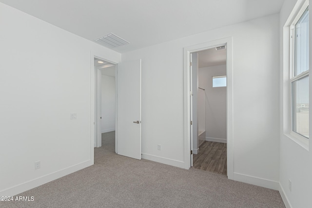 unfurnished bedroom with light colored carpet