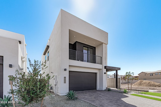 contemporary house with a balcony and a garage