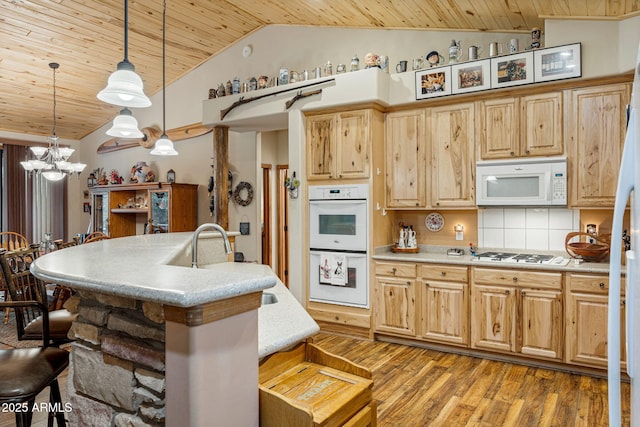 420 N Retreat Dr, Show Low, AZ 85901 - kitchen featuring wood ceiling, white appliances, a kitchen breakfast bar, light wood-style floors, and light countertops