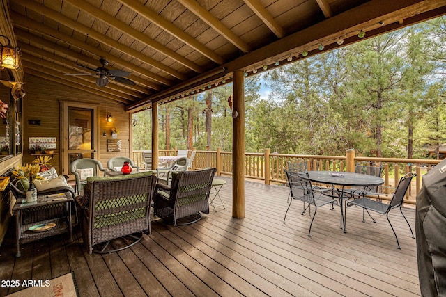 420 N Retreat Dr, Show Low, AZ 85901 - wooden terrace featuring outdoor dining space, a ceiling fan, and view of wooded area