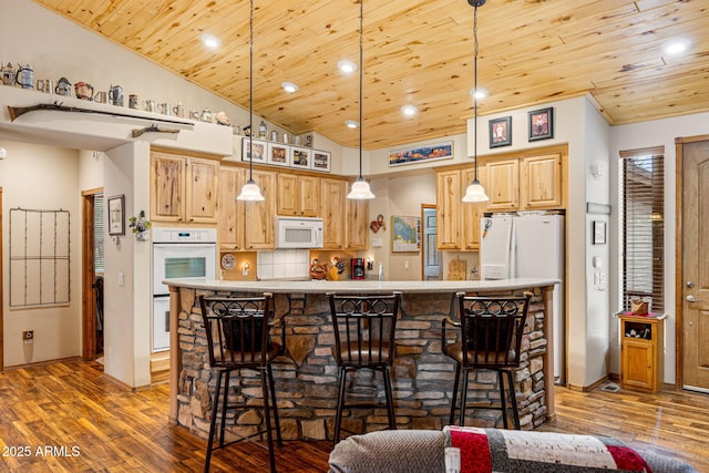 420 N Retreat Dr, Show Low, AZ 85901 - kitchen with white appliances, wood ceiling, light brown cabinetry, hardwood / wood-style flooring, and lofted ceiling