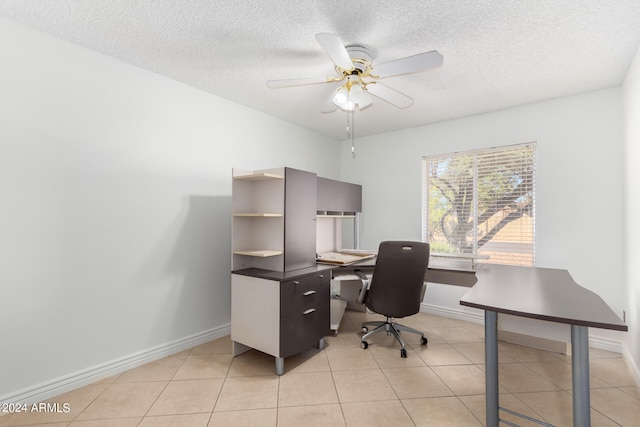 office space featuring ceiling fan, light tile patterned floors, and a textured ceiling