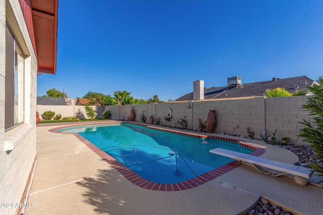 view of pool featuring a diving board and a patio area