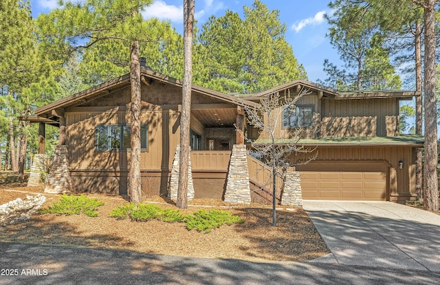 view of front of home featuring a garage, driveway, and a chimney