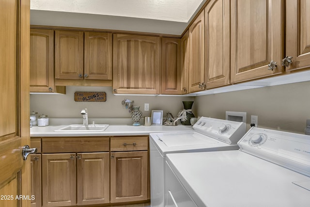 washroom featuring cabinet space and independent washer and dryer